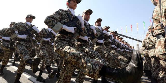 Iranian soldiers march past President Hassan Rowhani during an annual military parade in Tehran, on September 22, 2013
