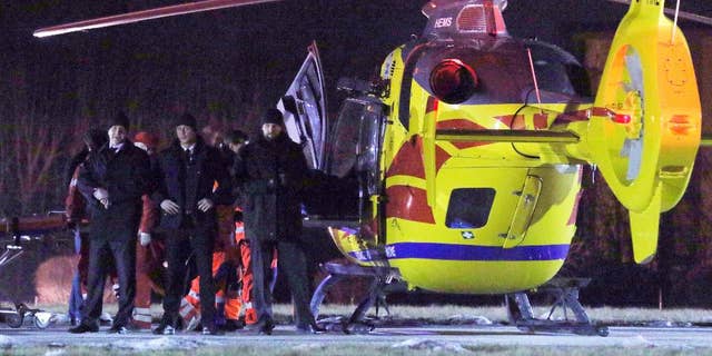 Security officers guard a rescue helicopter as Polish Prime Minister Beata Szydlo is transported to it after a car accident in Oswiecim, Poland, Friday, Feb. 10, 2017. Szydlo suffered minor injuries Friday after a small Fiat hit her car, officials and Polish news reports said. Her spokesman said she was being examined in a hospital but wasn't badly hurt. (AP Photo)
