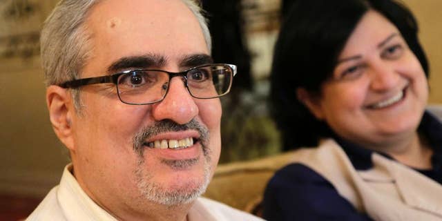 FILE -- In this June 20, 2015 file photo, Bahraini Sunni Muslim opposition leader Ibrahim Sharif, who led the secular opposition WAAD (National Democratic Action Society) group, sits with his wife Farida Ghulam at their home, in Tubli, Bahrain. The Bahrain Institute for Rights and Democracy, a Bahraini rights group, said political activist Ibrahim Sharif has been freed from prison Monday, July 11, 2016, after serving a yearlong sentence over comments he made last year. The rights group said Sharif was released but is at risk of being arrested again because of an appeal by prosecutors, who are seeking an extended sentence. (AP Photo/Hasan Jamali, File)