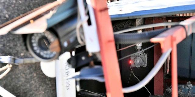 Surveillance cameras seen here outside a house where the body of Airi Kakimoto was found.