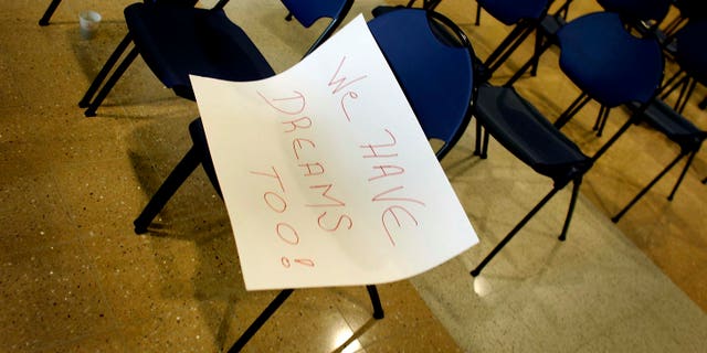MIAMI - MARCH 12: A sign with the words, " We have dreams too!", lays on a chair after a press conference to announce The American Dream Act March 12, 2007 at Florida International University in Miami, Florida. The bill, if passed in the United States Congress, would allow for undocumented immigrant students to obtain in-state tuition as well as permit those students, along with those serving in the military, to obtain a green card and legally remain in the United States. (Photo by Joe Raedle/Getty Images)