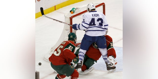 Toronto Maple Leafs center Nazem Kadri (43) collides with Minnesota Wild goalie Niklas Backstrom, of Finland, during the first period of an NHL hockey game in St. Paul, Minn., Wednesday, Nov. 13, 2013. Backstrom left the game later in the period. (AP Photo/Ann Heisenfelt)