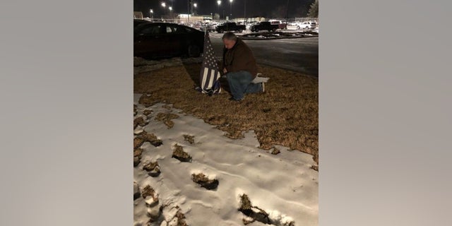 A man mourns the death of a Colorado sheriff's deputy Wednesday night in Thornton.