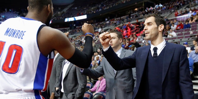 Detroit Pistons guard Jose Calderon, right, gets a fist bump from center Greg Monroe (10) before the Pistons' NBA basketball game against the Cleveland Cavaliers on Friday, Feb. 1, 2013, in Auburn Hills, Mich. Calderon was acquired in a trade from the Toronto Raptors but did not play Friday. (AP Photo/Duane Burleson)
