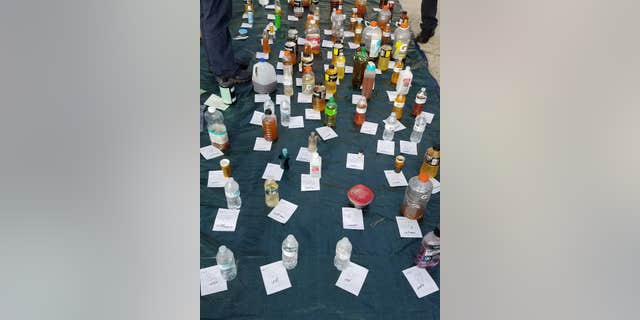 Langer allegedly had bottles of liquids, with most of them filled with bodily fluids, police said.