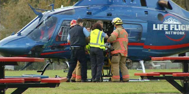 November 3, 2013: A police officer is loaded onto a helicopter after being shot responding to a fire in Oregon City, Ore. (Courtesy KPTV)