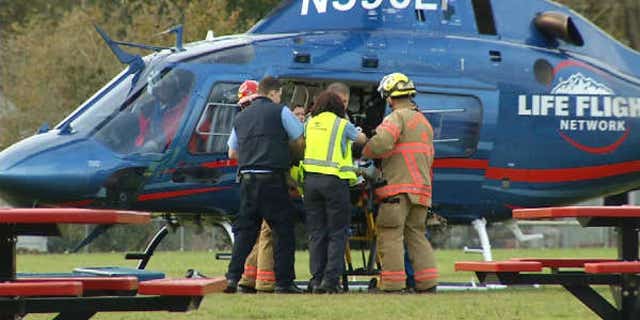 November 3, 2013: A police officer is loaded onto a helicopter after being shot responding to a fire in Oregon City, Ore. (Courtesy KPTV)