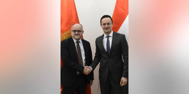 Montenegrin Foreign Minister Srdjan Darmanovic, left, and Hungarian Minister of Foreign Affairs and Trade Peter Szijjarto shake hands during their meeting in the Ministry of Foreign Affairs and Trade in Budapest, Hungary, Friday, Jan. 27, 2017. (Lajos Soos/MTI via AP)
