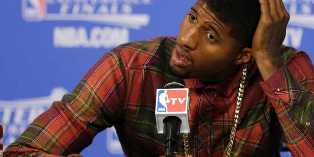 Indiana Pacers forward Paul George speaks during the post-game news conference after Game 4 in the NBA basketball Eastern Conference finals playoff series, Tuesday, May 27, 2014, in Miami. The Heat won 102-90. (AP Photo/Wilfredo Lee)