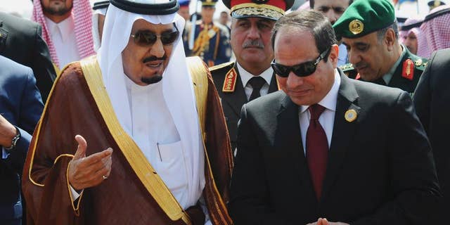 FILE -- In this March 28, 2015 file photo provided by Egypt's state news agency MENA, Egyptian President Abdel-Fattah el-Sissi, right, talks with Saudi King Salman after the king arrived in Sharm el-Sheikh, Egypt. Close allies Egypt and Saudi Arabia are having their first public spat since Egyptian President Abdel-Fattah el-Sissi took office two years ago. The disagreement is over Syria, where Riyadh says Syrian President Bashar Assad must be removed for that country's civil war to end, while Cairo advocates a political process that denies Islamic militants any role in Syria's future. Egypt voted in favor of separate Russian and French draft resolutions on Syria at the U.N. Security Council on Saturday, Oct. 8, 2016. (MENA via AP, File)