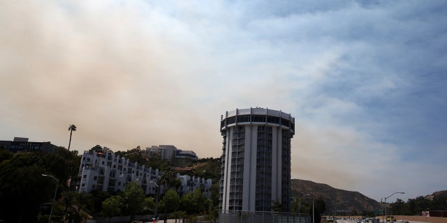 FILE: A wildfire burns behind Getty Center in Mandeville Canyon in Los Angeles