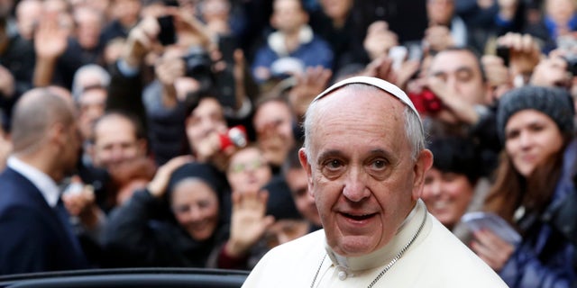 Pope Francis leaves Rome's Jesus' Church after celebrating a mass with the Jesuits, on the occasion of the order's titular feast, Friday, Jan. 3, 2014. (AP Photo/Riccardo De Luca)