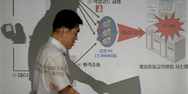A South Korean police officer of the National Police Agency shows how hacker attacks, believed to have come from North Korea, struck the agency's headquarters in Seoul.