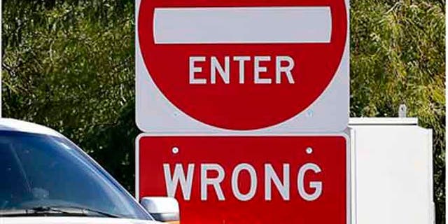 Signs warning drivers not to enter are shown on the Kyrene exit of the Loop 202, Monday, Nov. 23, 2015 in Chandler, Ariz. Arizona transportation officials are responding to a flurry of deadly wrong-way crashes with a plan for a test project on a Phoenix freeway that includes using sensors to detect wrong-way drivers and alert authorities and other motorists. (AP Photo/Matt York)