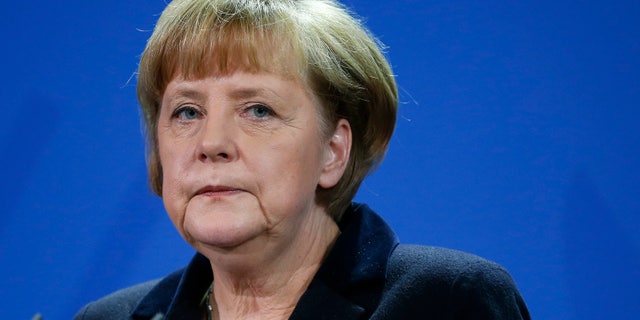 German Chancellor Angela Merkel attends a joint press conference with the Prime Minister of Greece, Andonis Samaras, after a meeting at the chancellery in Berlin, Germany, Friday, Nov. 22, 2013. (AP Photo/Michael Sohn)