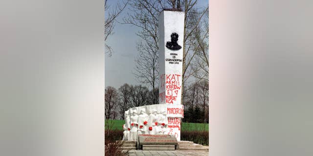 FILE- In this April 30, 2001 file photo taken in Pieniezno, Poland, graffiti with insults like “Murderer” and “Shame” can be seen on a memorial to Soviet General Ivan Chernyakhovsky, who is considered a symbol of the imposition of communism in Poland, but a national hero in Russia. Russian Ambassador Sergey Andreev on Friday described the Soviet's 1939 invasion of Poland as an act of self-defense, not aggression. The comment prompted Poland's Foreign Ministry to declare Saturday, Sept. 26, 2015, that the ambassador "undermines historical truth" and seems to be trying to justify Stalinist crimes. (AP Photo/Wojtek Jakubowski, file) POLAND OUT