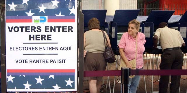 MIAMI - OCTOBER 21: Hispanic voters go to the polls for early voting at the Miami-Dade Government Center on October 21, 2004 in Miami, Florida. Early voting began this week in Florida and is under heavy scrutiny after the debacle in the 2000 election. (Photo by G. De Cardenas/Getty Images)