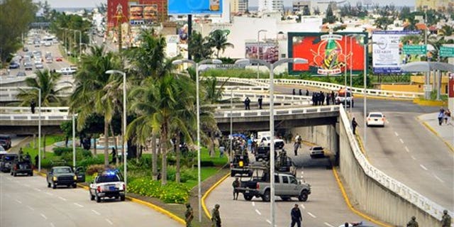 Mexican military arrests 'El Tony Montana', brother of nation's most needed cartel boss 4 Soldiers and police block off an area where 35 bodies lie under an overpass in Veracruz, Mexico.