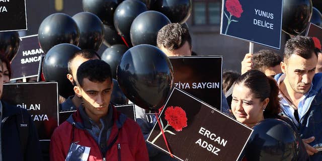 Members of youth organzations hold names of victims and black balloons as they gather at the site of twin explosions that killed 102 people and injured hundreds others more than two weeks ago outside the main train station in Ankara, Turkey, Monday, Oct. 26, 2015. (AP Photo)