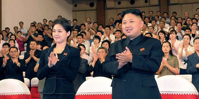 July 6, 2012:  North Korean leader Kim Jong Un, center right, and wife Ri Sol-ju clap.