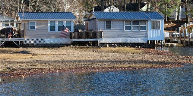 Waterfront cabins are seen on Lake Winnipesaukee Thursday, Nov. 17, 2016, in Laconia, N.H. The long-running drought in much of the Northeastern United States is expected to persist through the winter. The U.S. Drought Monitor map released Thursday shows dry conditions continuing through February throughout New England. (AP Photo/Jim Cole)