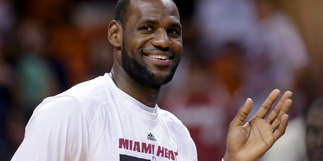 Miami Heat small forward LeBron James (6) waves to fans during a timeout of an NBA preseason basketball game against the Brooklyn Nets, Friday, Oct. 25, 2013, in Miami. The Nets won 108-87. (AP Photo/Alan Diaz)