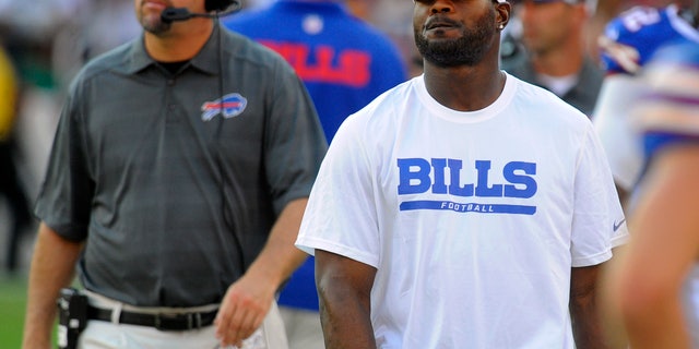 FILE - In this Aug. 24, 2013, file photo, Buffalo Bills safety Jairus Byrd, center, looks on from the sideline in the second half of an NFL preseason football game against the Washington Redskins in Landover, Md. After missing the entire offseason because of a contract dispute and first five games of the regular season due to sore feet, Byrd is finally ready to take the field. Byrd is expected to play Sunday, when the Bills host the Cincinnati Bengals. (AP Photo/Richard Lipski, File)