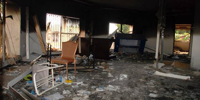 In this Sept.  December 12, 2012 file photo, glass, debris and overturned furniture are strewn across the room of the destroyed US consulate in Benghazi, Libya, following an attack that killed four Americans, including Ambassador Chris Stevens.