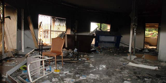 File photos, glass, debris, and flipped over in a room at the US Consulate in Benghazi, Libya, on September 12, 2012, after an attack that killed four Americans, including Ambassador Christopher Stevens. The furniture is scattered.