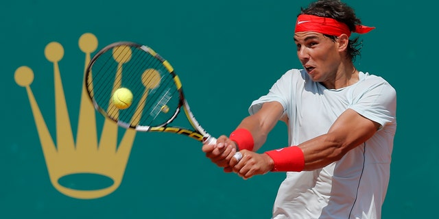 Spain's Rafael Nadal plays a return to Philipp Kohlschreiber of Germany during their match of the Monte Carlo Tennis Masters tournament in Monaco, Thursday, April 18, 2013. (AP Photo/Lionel Cironneau)