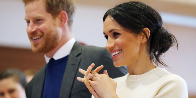While touring the Titanic Belfast, Markle wore her dark hair pulled back into a low messy bun, only this time it was swept off to one side.