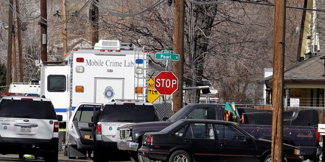 Feb. 6, 2013: Police investigate the scene of a shooting where a woman and two children were found dead and a third child wounded in the Globeville neighborhood in Denver.