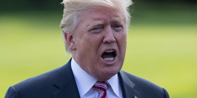 FILE -- In this Sept. 29, 2017 file photo, President Donald Trump talks to media as he walks across the South Lawn of the White House in Washington.