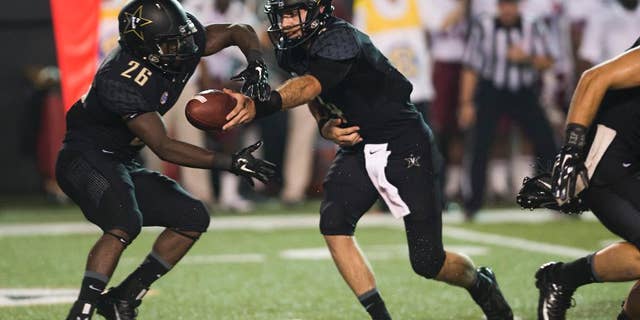 Vanderbilt quarterback Patton Robinette, right, hands off the ball to running back Ralph Webb (26) in the first quarter of an NCAA college football game against Temple on Thursday, Aug. 28, 2014, in Nashville, Tenn. (AP Photo/Brian Powers)