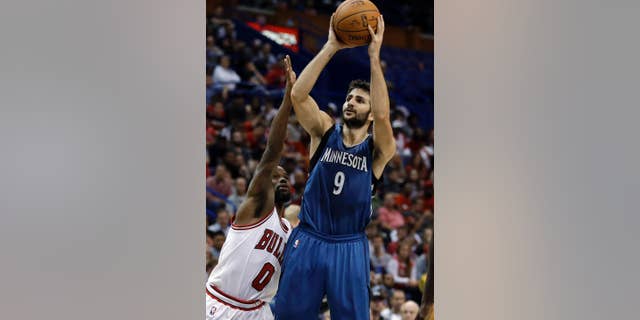 Minnesota Timberwolves' Ricky Rubio, right, shoots as Chicago Bulls' Aaron Brooks defends during the second half of a preseason NBA basketball game Friday, Oct. 24, 2014, in St. Louis. The Timberwolves won 113-112. (AP Photo/Jeff Roberson)