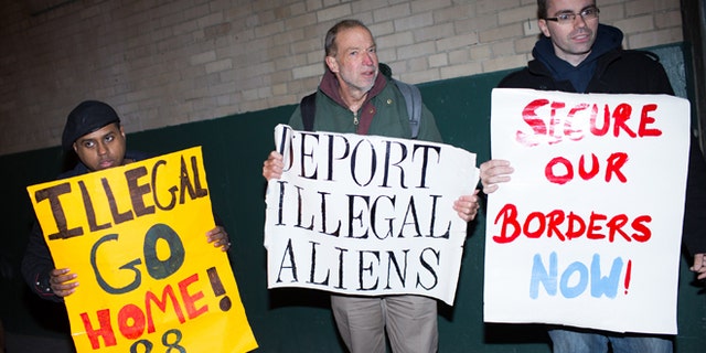 NEW YORK, NY - NOVEMBER 20: Jim MacDonald (C) and fellow activists from the organization New Yorkers for Immigration Control and Enforcement (NY ICE) hold protest signs outside the offices of 32BJ SEIU, a workers union, during a viewing party for U.S. President Barack Obama's speech on evecutive action immigration policy reform on November 20, 2014 in New York City. In his announcement, the president detailed his plans to take executive action to provide administrative relief to millions of immigrants. (Photo by Kevin Hagen/Getty Images)