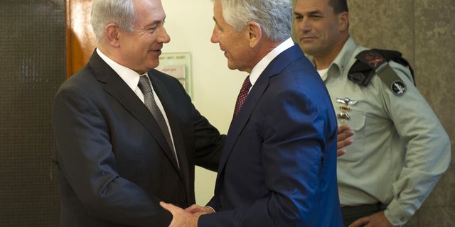 Israeli Prime Minister Benjamin Netanyahu, left, welcomes U.S. Secretary of Defense Chuck Hagel at his office in Jerusalem, on Tuesday, April 23, 2013. Hagel said the U.S. and Israel need to ensure that their alliance is "closer than ever," as Mideast security challenges grow more complicated. (AP Photo/Jim Watson, Pool)