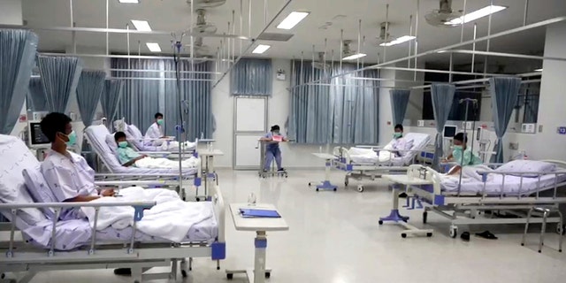 Image made from video shot Friday shows some of the 12 boys rescued from the flooded cave, in their hospital room at Chiang Rai Prachanukroh Hospital in northern Thailand.