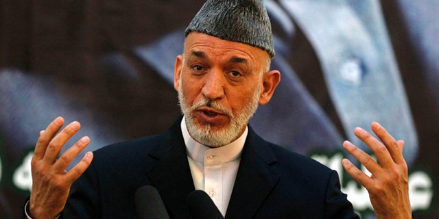 June 18, 2013: Afghan President Hamid Karzai speaks during a joint news conference with NATO Secretary-General Anders Fogh Rasmussen following a security handover ceremony at a military academy outside Kabul.