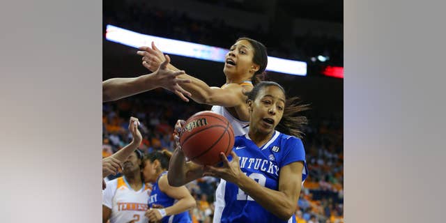 Kentucky forward/center Jelleah Sidney (12) rebounds in front of Tennessee center Isabelle Harrison, top, in the first half of an NCAA college basketball game in the finals of the Southeastern Conference women's tournament on Sunday, March 9, 2014, in Duluth, Ga. (AP Photo/Jason Getz)