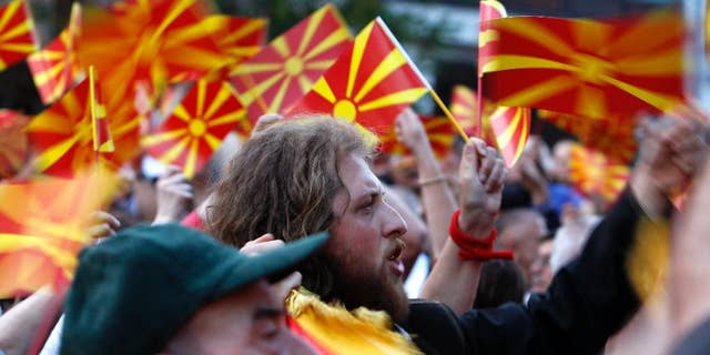 People wave Macedonian flags during a paceful protest in front of the EU mission building in Skopje, Macedonia, Friday, April 28, 2017. 
About 2,000 protesters have gathered in Macedonia’s capital Skopje to demand new elections to try and break the country’s political deadlock, a day after violent protests inside the country’s parliament. (AP Photo/Boris Grdanoski)