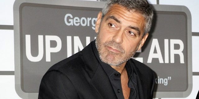 Actor George Clooney, star of the film "Up in the Air" poses on the red carpet at the film's premiere in Los Angeles (REUTERS)