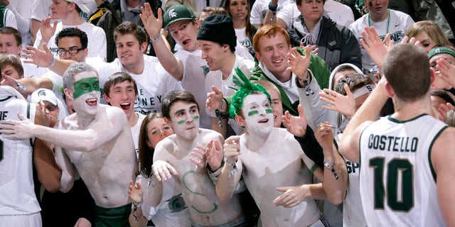 Michigan State fans greet players, including Matt Costello (10), following a 75-52 win over Michigan in an NCAA college basketball game, Tuesday, Feb. 12, 2013, in East Lansing, Mich. (AP Photo/Al Goldis)