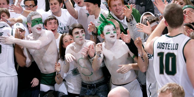 Michigan State fans greet players, including Matt Costello (10), following a 75-52 win over Michigan in an NCAA college basketball game, Tuesday, Feb. 12, 2013, in East Lansing, Mich. (AP Photo/Al Goldis)