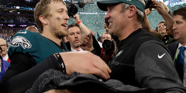 Philadelphia Eagles' Nick Foles, left, celebrates with head coach Doug Pederson after the NFL Super Bowl 52 football game against the New England Patriots Sunday, Feb. 4, 2018, in Minneapolis. The Eagles won 41-33. (AP Photo/Matt Slocum)