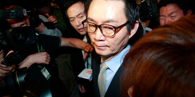 South Korean President Park Geun-hye's spokesman Yoon Chang-jung surrounded by journalists leaves after a press conference in Seoul, South Korea, Saturday, May 11, 2013. Park fired Yoon because of what her office said Friday was a “disgraceful incident” during Park’s trip to the United States, in what could be a domestic blow after an otherwise widely praised appearance in Washington. Without elaborating, the presidential Blue House said on its website that unspecified actions by Yoon marred the government’s dignity. (AP Photo/Ahn Young-joon)