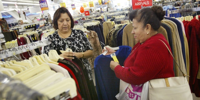 CHICAGO - OCTOBER 24: Sales associate Maria Ayala (L) helps Carmen Anzo shop for clothing in a store located in Chicago's largely Hispanic Little Village neighborhood October 24, 2003 in Illinois. According to the U.S. Census Bureau, reports show that the nation's Hispanic population has grown to become the largest minority. (Photo by Tim Boyle/Getty Images)