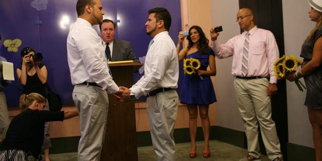 Marcos A. Chaljub, left, and Freddy L. Sambrano exchange vows at the Manhattan City Clerk's office  on the first day New York State's Marriage Equality Act goes into effect, on Sunday, July 24, 2011, in New York.   (AP Photo/Michael Appleton, Pool)