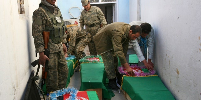 April 17, 2013: Afghan Army soldiers prepare the coffins for their killed comrades in the morgue of the main hospital in Ghazni, Afghanistan. A roadside bomb killed the five soldiers who were part of a government security force guarding a convoy of trucks in Ghazni's Qarabagh district. Roadside bombs and insurgent attacks killed dozens of people in five separate attacks across Afghanistan as violence steadily rises during this year's spring fighting season, officials said Wednesday.