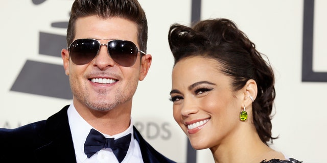 Singer Robin Thicke and wife, actress Paula Patton, arrive at the 56th annual Grammy Awards in Los Angeles, California January 26, 2014.     REUTERS/Danny Moloshok (UNITED STATES TAGS: ENTERTAINMENT) (GRAMMYS-ARRIVALS) - RTX17W6V